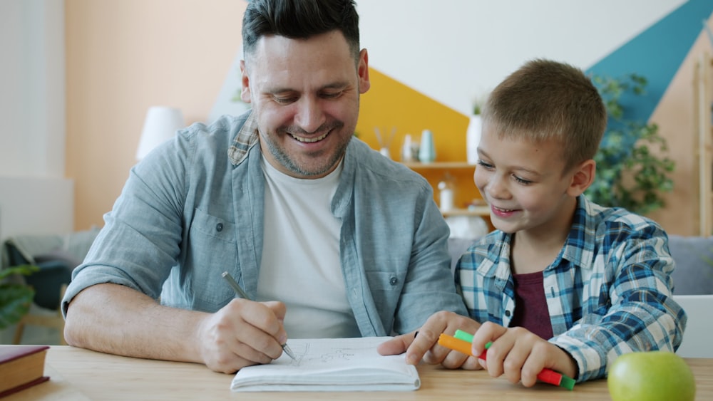 Tutor and student smiling together while working through a problem